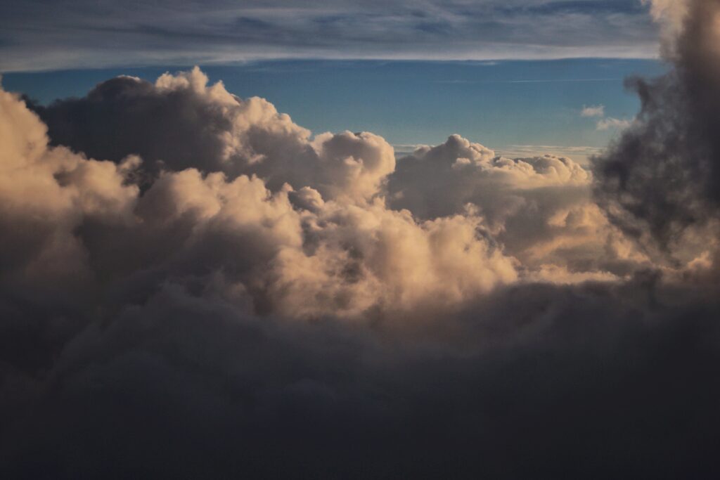 A cloudy sky during the evening with a subtle dark overlay