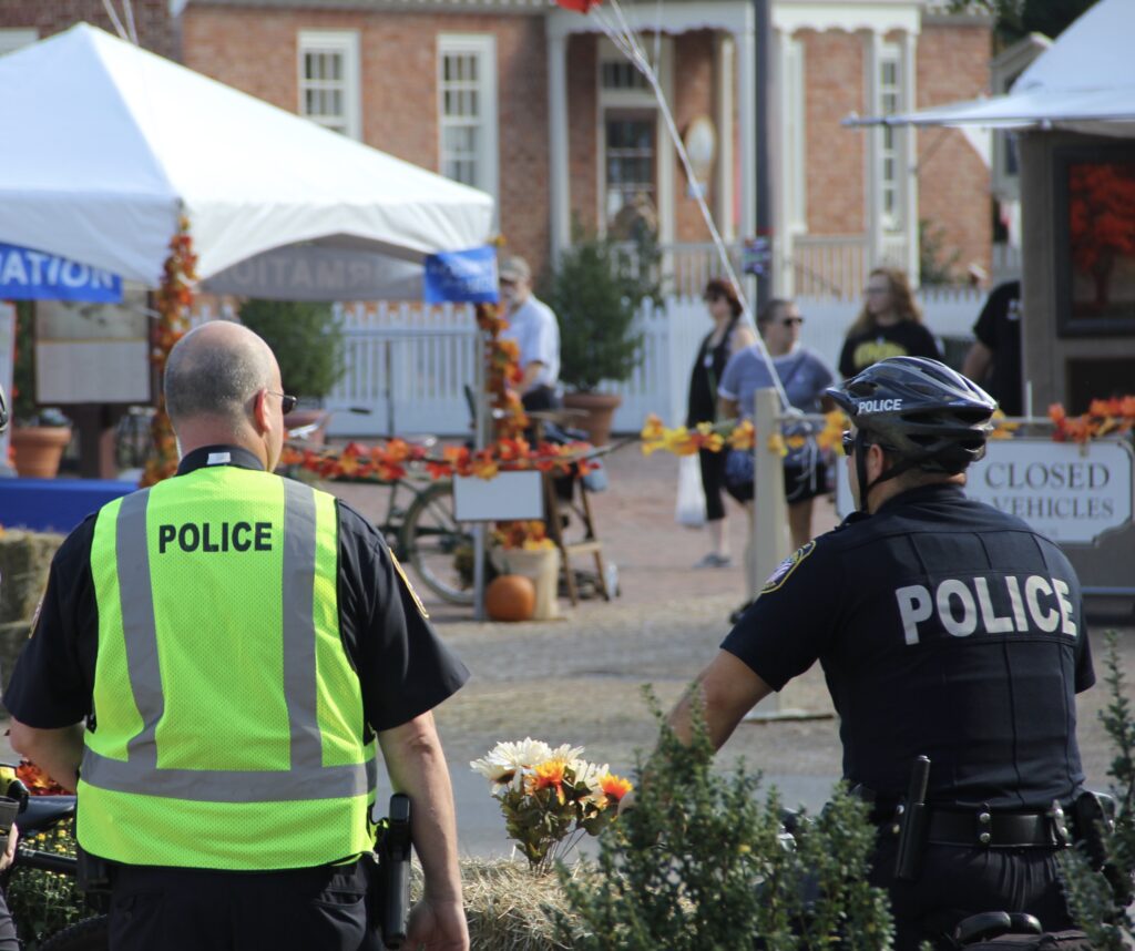 Police offers stand by a crime scene in a city